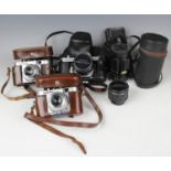 A collection of cameras and accessories, including two Voigtländer Vito B cameras, a Pentax