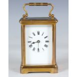 A late 19th century French lacquered brass carriage timepiece, the enamelled dial with Roman hour