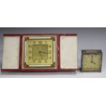 An Art Deco gilt metal and enamelled bedside alarm clock, the gilt dial with Arabic hour numerals,