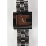 A Gucci steel bracelet wristwatch, designed as the letter 'G' and detailed 'Gucci Swiss Made' to the