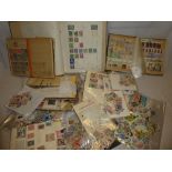 A box of various World stamps in packets, album pages, covers,