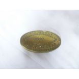 A brass Welsh Miner's oval snuff box engraved "T.H.