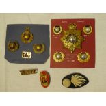 A small collection of Royal Marines insignia including Officer's silver gilt King's Crown helmet