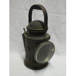 An old brass mounted painted metal Railway hand lamp with internal burner and reflector,