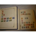 A boxed folder album containing a selection of World stamps, mainly Holland,