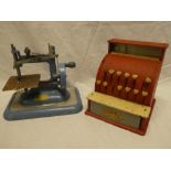 A childs Codeg metal cash register and a childs Vulcan sewing machine (2)