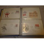 An album containing a collection of over 70 British Commonwealth first day covers 1964-1971