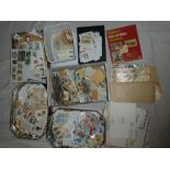 A large box containing various World covers, GB stamps, stamps on/off paper and stamps in packets,