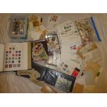 Various tins containing packets of World stamps, empty folder album, various covers,