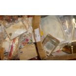 A box containing various World stamps in packets, boxes,