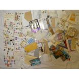 A box containing a large selection of World stamps in packets, first day covers, presentation packs,