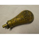 A 19th Century brass pistol powder flask with raised eagle and foliage decoration