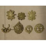 Seven original Highland cap badges including 5th Seaforth Highlanders, Loval Scouts, Black Watch,