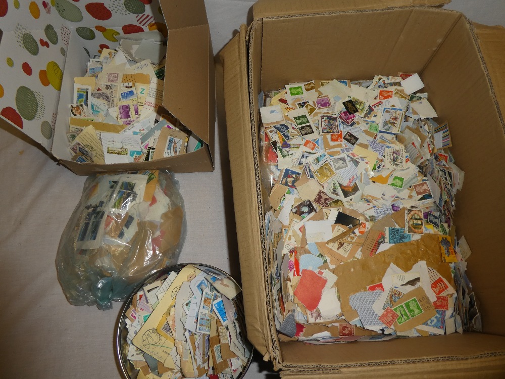 A box containing GB stamps on paper together with various World stamps,