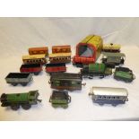 A Hornby tinplate O gauge M-series clockwork locomotive with eight various wagons, five coaches,