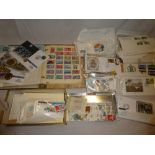 A box containing assorted postal covers and cards, albums, loose stamps,