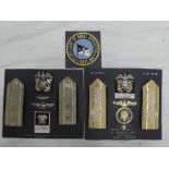 A display of US Navy insignia including Admirals epaulettes and badges serving as a Presidential