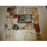 Three stock books containing a selection of World stamps together with numerous tins of stamps,