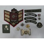 A collection of Irish Guards badges and insignia including Officers silver and enamel cap badge,