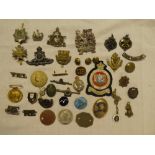 A selection of various military badges including Connaught Rangers, bronze RA, Boys Brigade,