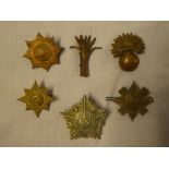 A Guard Machine Gun Corps cap badge and five Guards cap badges including Welsh Guards,