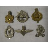 Six original military cap badges including Parachute Regiment, Artist Rifles, A.A.C.