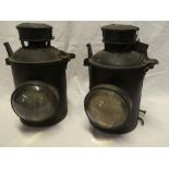 A pair of painted metal Railway bracket lamps with bulls-eye glass lenses and original internal
