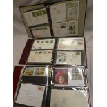 Three albums containing a selection of GB first day covers 1970's-1990's together with stamp