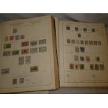 A collection of British Empire and World stamps contained in four old folder albums,