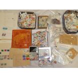 A box containing GB and World stamps on paper, album leaves, packets,