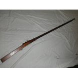 An old Indian torrador matchlock musket with 47" steel flared barrel and polished wood stock