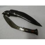 A Gurkha service Kukri with curved single edged blade and wood hilt in leather sheath