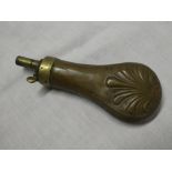 A 19th Century brass mounted copper pistol powder flask with raised acanthus decoration
