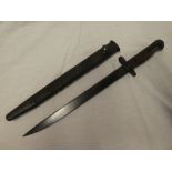 A British Enfield India pattern Mk11 bayonet dated 1943 in leather scabbard