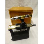 A painted metal and brass vernier microscope by Philip Harris of Birmingham in fitted wooden case
