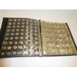 A folder album containing a collection of Foreign coins