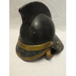 An old brass mounted leather Firemans helmet complete with liner and chinstrap
