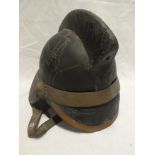 An old brass mounted leather Firemans helmet complete with liner and chinstrap by Hendry Ltd
