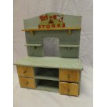 A Tri-ang painted wood "Stores" dresser with four drawers 15" high