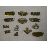 A selection of brass shoulder titles including Oxford University OTC, Cornwall,