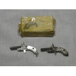 Two miniature working cap pistols as fobs,