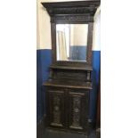 A Victorian carved oak slim hall dresser with cupboard enclosed by two panelled doors,