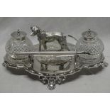 A good quality silver plated desk stand with central standing dog flanked by cut glass spherical