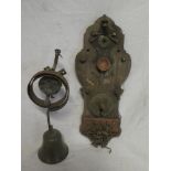 A Victorian bronze sprung door bell with bracket and a brass mounted wood bell indicator gauge (2)