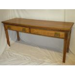 A Continental oak rectangular serving table with two drawers in the frieze on square shaped legs