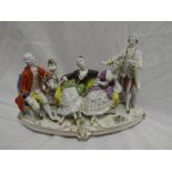 A Continental china group of an interior with two males and two females on oval base,
