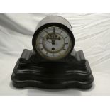 An Edwardian French mantel clock with gilt and enamelled circular dial marked "Paris" in ebonised