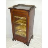 A Victorian walnut music cabinet with velvet lined shelves enclosed by single glazed door