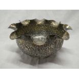 An Indian silver circular ornamental bowl decorated with palm trees and animals 7½" diameter