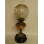 A Victorian/Edwardian copper oil lamp with leaf decorated stem and etched glass shade